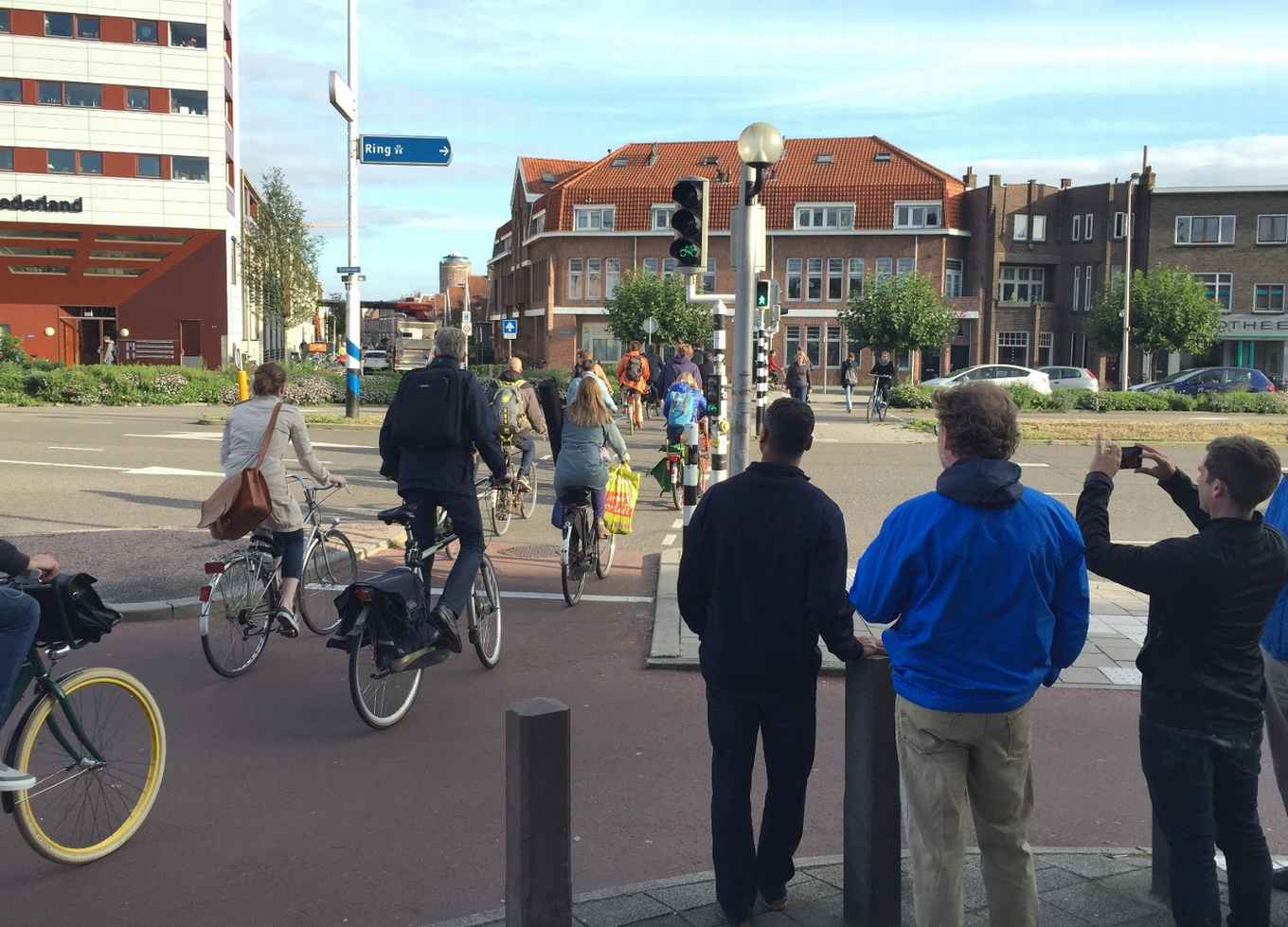 Study visit delegates from the U.S. observing a busy intersection during a guided bike tour. Utrecht, The Netherlands
