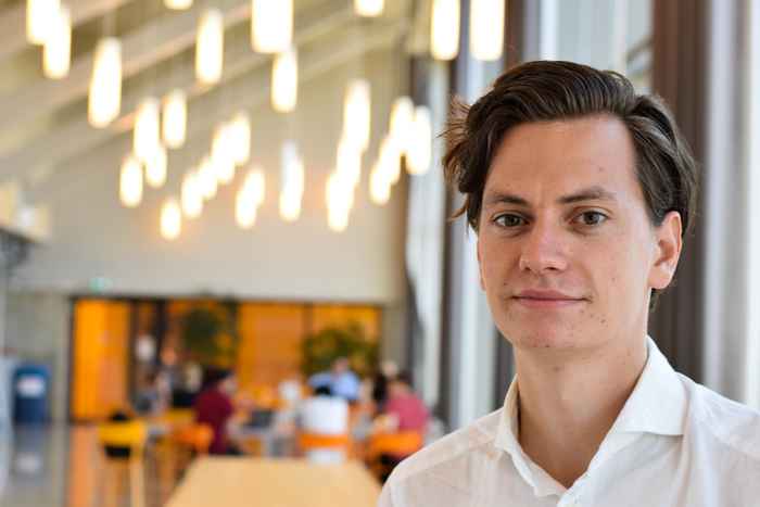 Student with white shirt with lights in the background