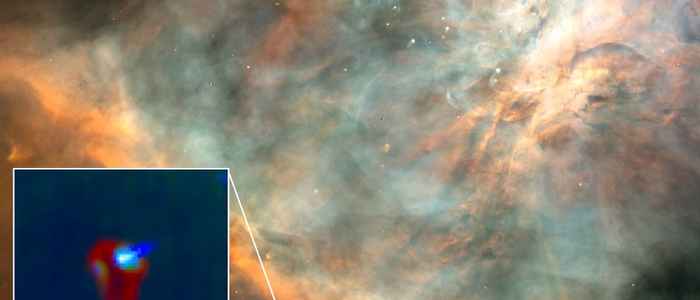 The protoplanetary disk d203-506 (bottom left) suffers so much from the UV radiation from heavy stars in the Trapezium cluster (top right) that a Jupiter-like planet-in-formation cannot form.