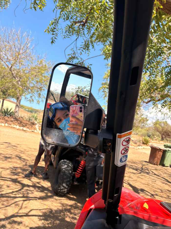 Selfie van Jada via de spiegel van een auto